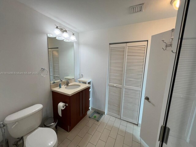 79 SW 12th St Unit 1603-S, Miami, FL 33130 - bathroom featuring a closet, vanity, and tile patterned floors