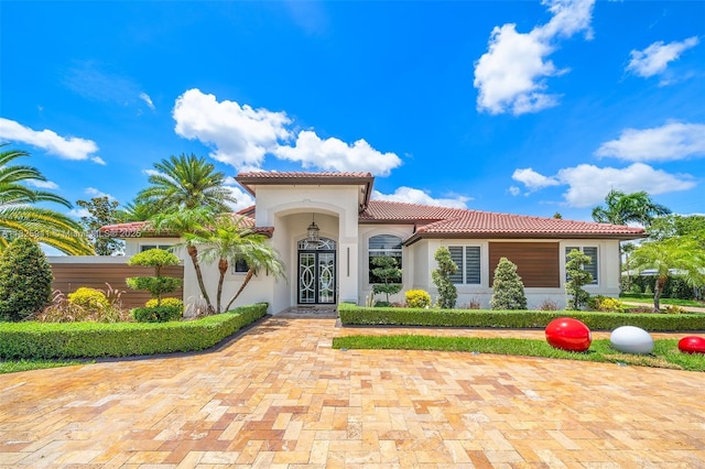17490 SW 70th Pl, Southwest Ranches, FL 33331 - mediterranean / spanish-style home featuring a tiled roof and stucco siding