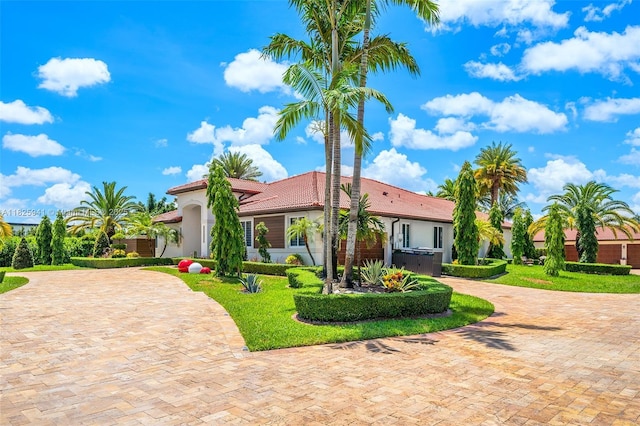 17490 SW 70th Pl, Southwest Ranches, FL 33331 - mediterranean / spanish home with curved driveway, stucco siding, and a tile roof