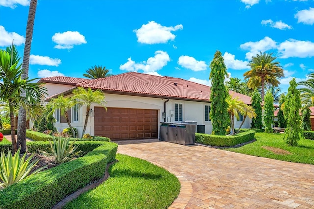 17490 SW 70th Pl, Southwest Ranches, FL 33331 - view of front of house featuring a tiled roof, stucco siding, a garage, decorative driveway, and a front yard