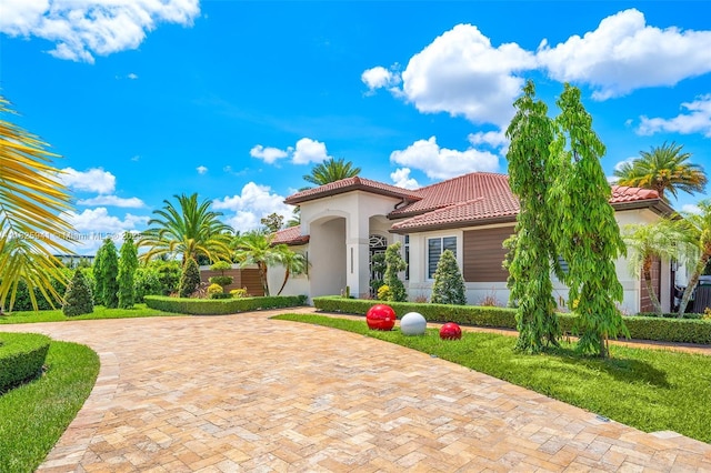 17490 SW 70th Pl, Southwest Ranches, FL 33331 - mediterranean / spanish house with a tile roof, stucco siding, and decorative driveway