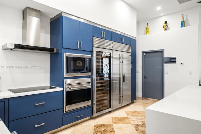 17490 SW 70th Pl, Southwest Ranches, FL 33331 - kitchen with wall chimney range hood, black appliances, blue cabinetry, light countertops, and recessed lighting