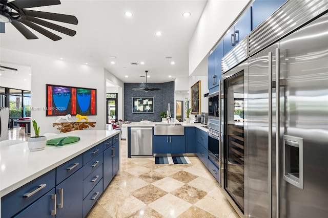 17490 SW 70th Pl, Southwest Ranches, FL 33331 - kitchen featuring stainless steel appliances, blue cabinets, a ceiling fan, open floor plan, and recessed lighting