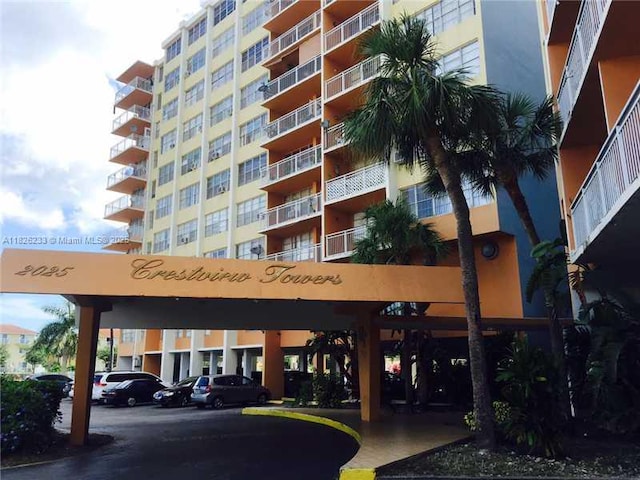 2025 NE 164th St Unit 901, North Miami Beach, FL 33162 - view of apartment building / complex featuring a parking lot