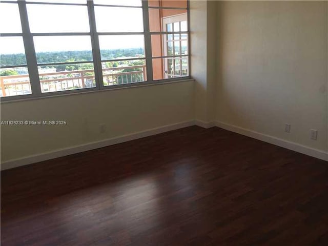 2025 NE 164th St Unit 901, North Miami Beach, FL 33162 - unfurnished room featuring dark wood-type flooring and baseboards