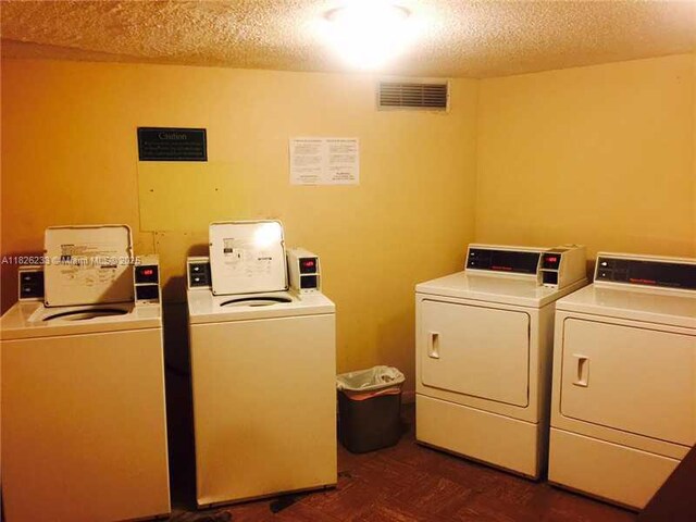 2025 NE 164th St Unit 901, North Miami Beach, FL 33162 - community laundry with separate washer and dryer and a textured ceiling