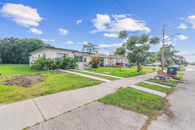 1408 N 23rd St, Fort Pierce, FL 34950 - view of front of property with a front lawn and driveway