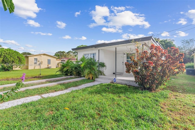 1408 N 23rd St, Fort Pierce, FL 34950 - view of front of house featuring a front yard and a porch