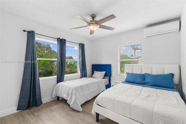 1408 N 23rd St, Fort Pierce, FL 34950 - bedroom with an AC wall unit, wood finished floors, a textured ceiling, and a ceiling fan