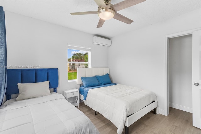 1408 N 23rd St, Fort Pierce, FL 34950 - bedroom with a wall mounted AC, wood finished floors, and ceiling fan