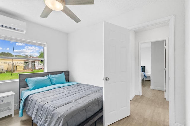 1408 N 23rd St, Fort Pierce, FL 34950 - bedroom featuring a wall mounted AC, light wood-style flooring, and a ceiling fan