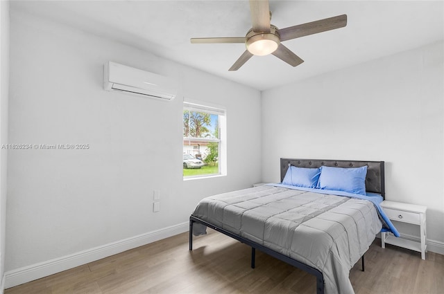1408 N 23rd St, Fort Pierce, FL 34950 - bedroom featuring an AC wall unit, wood finished floors, and a ceiling fan
