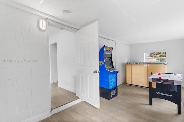 1408 N 23rd St, Fort Pierce, FL 34950 - recreation room featuring wood finished floors and concrete block wall