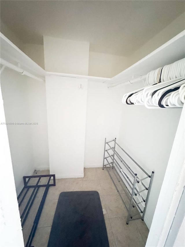 2025 NE 164th St Unit 206, North Miami Beach, FL 33162 - walk in closet featuring tile patterned flooring