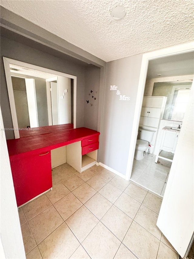 2025 NE 164th St Unit 206, North Miami Beach, FL 33162 - unfurnished dining area featuring a textured ceiling and tile patterned flooring