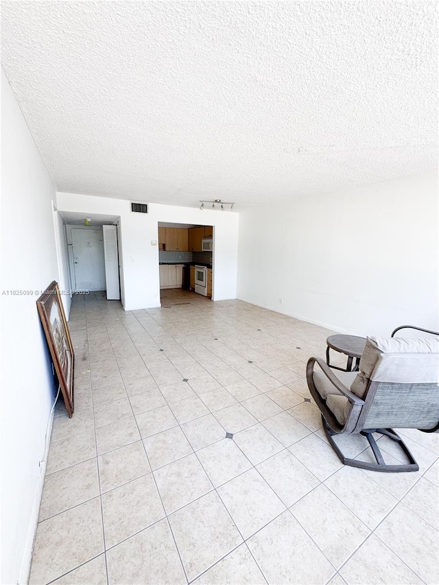 2025 NE 164th St Unit 206, North Miami Beach, FL 33162 - unfurnished living room featuring a textured ceiling
