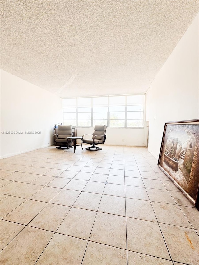 2025 NE 164th St Unit 206, North Miami Beach, FL 33162 - living area featuring a textured ceiling and light tile patterned floors