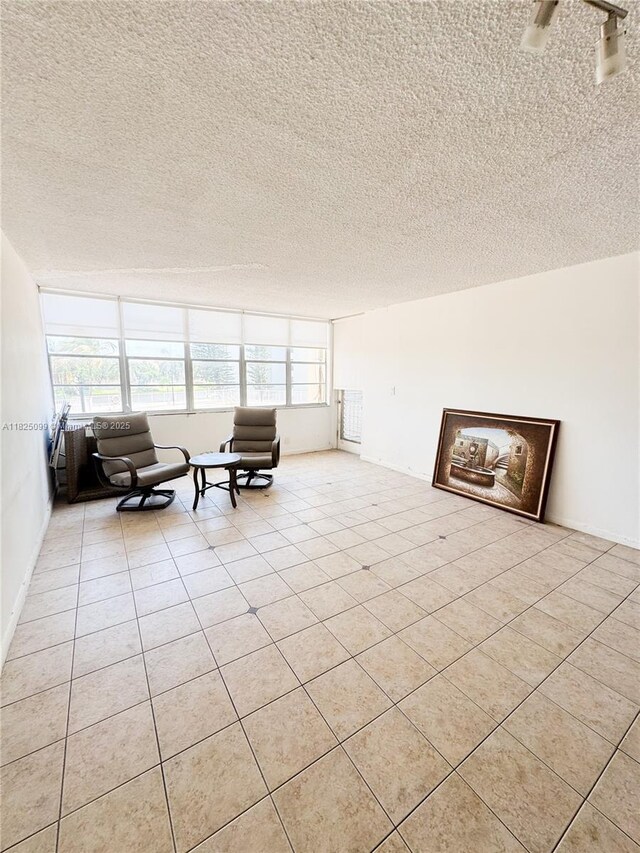 2025 NE 164th St Unit 206, North Miami Beach, FL 33162 - living area with a textured ceiling and light tile patterned floors