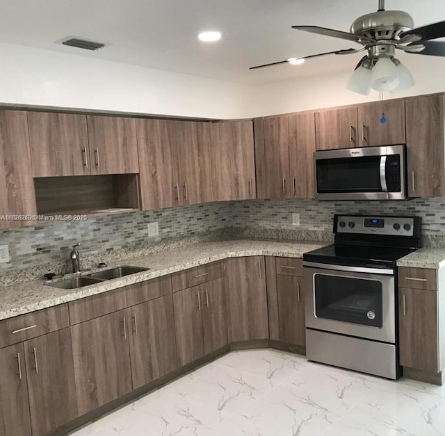 6710 SW 18th Ct, North Lauderdale, FL 33068 - kitchen with stainless steel appliances, backsplash, light marble finish flooring, and ceiling fan