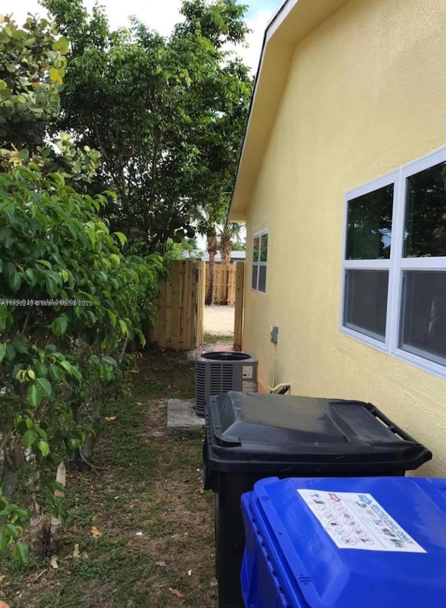 6710 SW 18th Ct, North Lauderdale, FL 33068 - view of side of home with stucco siding and a central AC unit