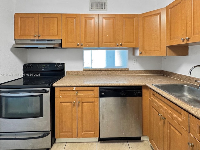 5201 Geneva Way Unit 201, Doral, FL 33166 - kitchen with stainless steel appliances, under cabinet range hood, light tile patterned flooring, and brown cabinets