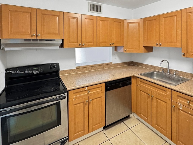 5201 Geneva Way Unit 201, Doral, FL 33166 - kitchen with appliances with stainless steel finishes, under cabinet range hood, light tile patterned flooring, and brown cabinetry