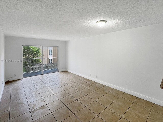 5201 Geneva Way Unit 201, Doral, FL 33166 - tiled spare room featuring a textured ceiling and baseboards