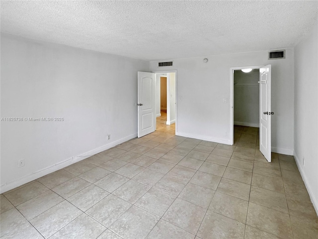 5201 Geneva Way Unit 201, Doral, FL 33166 - empty room with light tile patterned flooring and a textured ceiling