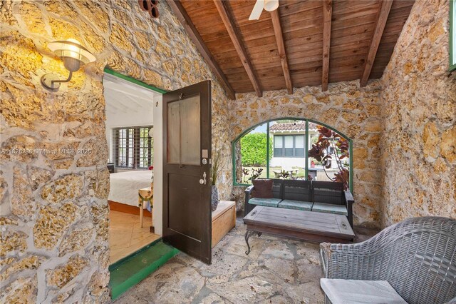 1301 Milan Ave Unit 4, Coral Gables, FL 33134 - living area featuring a wood ceiling with exposed beams, stone flooring, and high vaulted ceiling