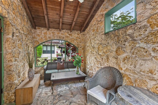 1301 Milan Ave Unit 4, Coral Gables, FL 33134 - living area with a wood ceiling with exposed beams, stone flooring, and high vaulted ceiling