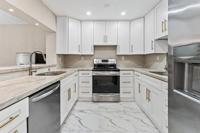 919 NE 4th St, Hallandale Beach, FL 33009 - kitchen featuring appliances with stainless steel finishes, light marble finish flooring, white cabinetry, recessed lighting, and light stone counters