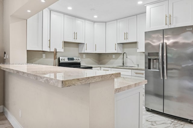 919 NE 4th St, Hallandale Beach, FL 33009 - kitchen featuring stainless steel appliances, a peninsula, recessed lighting, white cabinetry, and light stone countertops