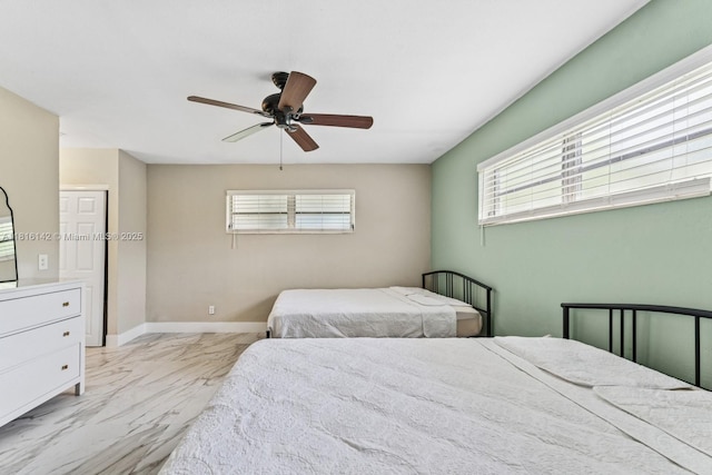 919 NE 4th St, Hallandale Beach, FL 33009 - bedroom featuring marble look tile flooring, multiple windows, and a ceiling fan