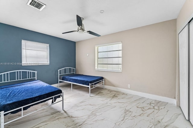 919 NE 4th St, Hallandale Beach, FL 33009 - bedroom featuring a closet, marble look tile flooring, and a ceiling fan