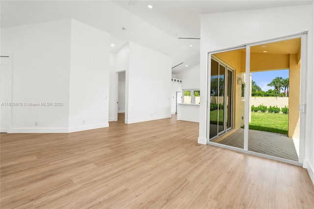 9047 Baybury Ln, West Palm Beach, FL 33411 - unfurnished living room with light wood-style flooring, recessed lighting, and high vaulted ceiling