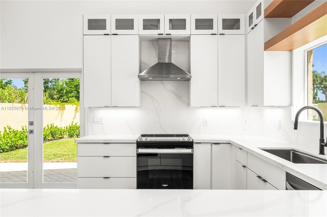9047 Baybury Ln, West Palm Beach, FL 33411 - kitchen with wall chimney range hood, electric range, white cabinetry, and glass insert cabinets