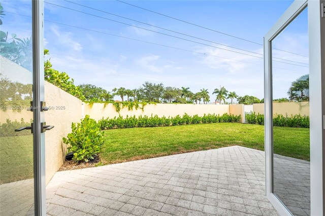9047 Baybury Ln, West Palm Beach, FL 33411 - fenced backyard featuring a patio area