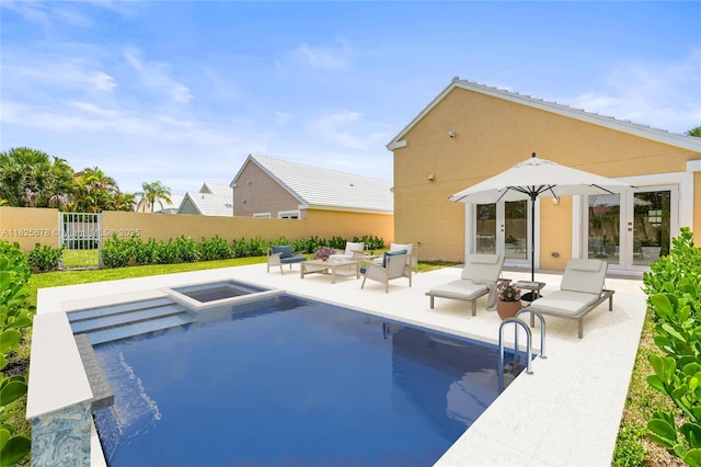 9047 Baybury Ln, West Palm Beach, FL 33411 - view of swimming pool with french doors, a patio area, and a pool with connected hot tub