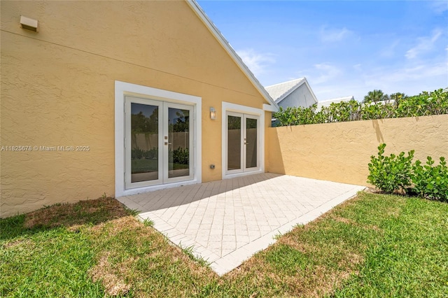 9047 Baybury Ln, West Palm Beach, FL 33411 - back of house featuring stucco siding, french doors, and a patio
