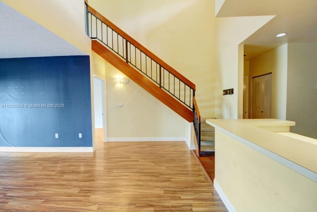 14716 Breckness Pl, Miami Lakes, FL 33016 - unfurnished living room featuring wood finished floors, stairway, and recessed lighting