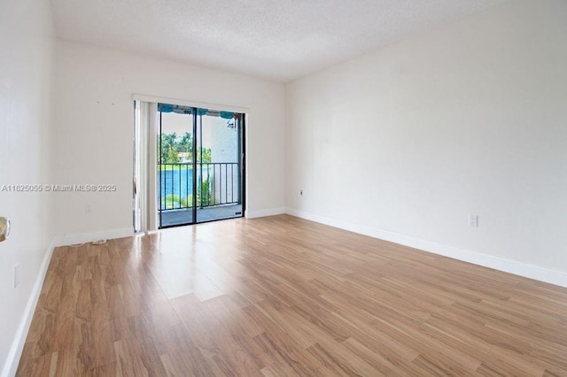 14716 Breckness Pl, Miami Lakes, FL 33016 - unfurnished room with light wood finished floors and a textured ceiling