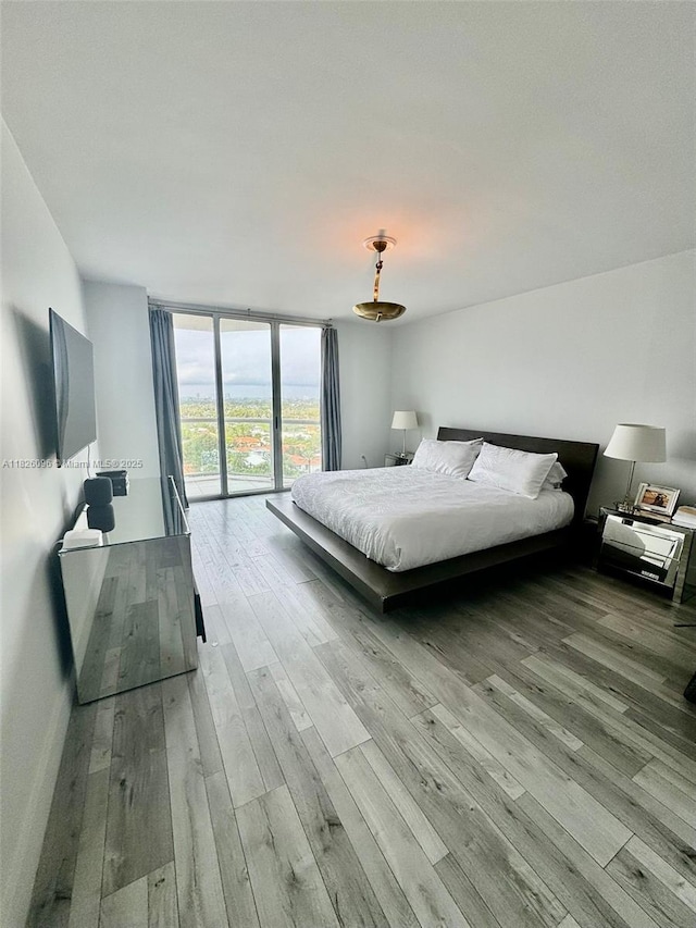 8925 Collins Ave Unit 9G, Surfside, FL 33154 - bedroom featuring wood finished floors, expansive windows, and access to outside
