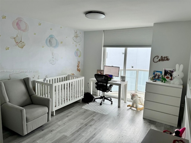 8925 Collins Ave Unit 9G, Surfside, FL 33154 - bedroom featuring light wood finished floors, a desk, and a crib