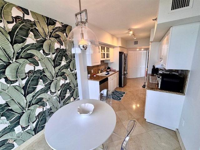 8925 Collins Ave Unit 9G, Surfside, FL 33154 - kitchen featuring appliances with stainless steel finishes, white cabinets, glass insert cabinets, tasteful backsplash, and dark countertops