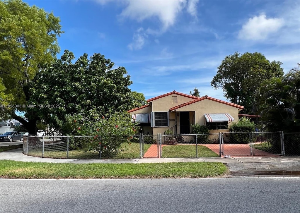 3880 NW 2nd Ter, Miami, FL 33126 - ranch-style home featuring a gate, a fenced front yard, and stucco siding