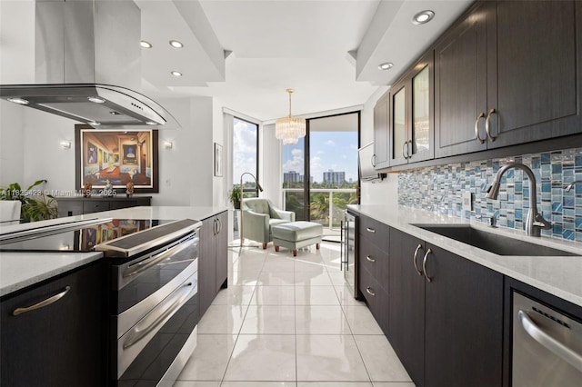 20281 E Country Club Dr Unit 201, Aventura, FL 33180 - kitchen featuring appliances with stainless steel finishes, island range hood, decorative backsplash, recessed lighting, and expansive windows