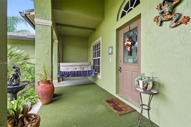 1025 SW Placetas Ave, Port St Lucie, FL 34953 - view of exterior entry with stucco siding and covered porch