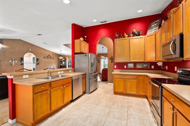 1025 SW Placetas Ave, Port St Lucie, FL 34953 - kitchen with stainless steel appliances, arched walkways, a peninsula, brown cabinetry, and recessed lighting