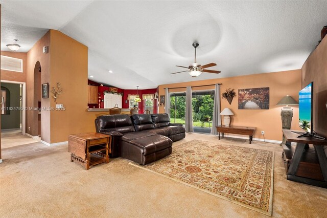 1025 SW Placetas Ave, Port St Lucie, FL 34953 - carpeted living room with arched walkways, a ceiling fan, and vaulted ceiling