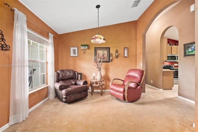 1025 SW Placetas Ave, Port St Lucie, FL 34953 - sitting room with arched walkways and light carpet